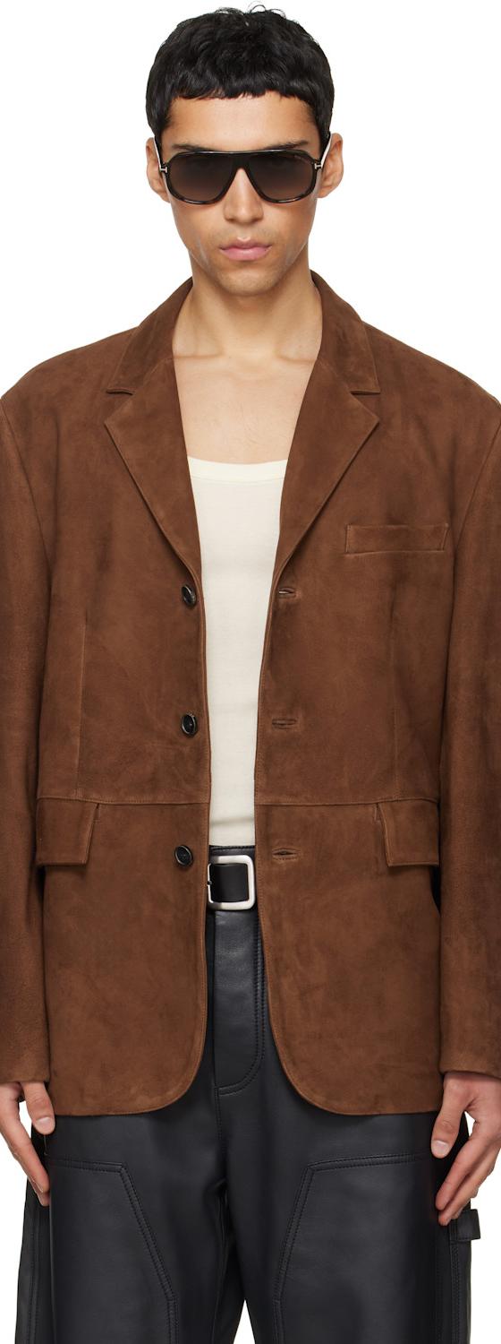 A man wearing a brown suede TONYWACK blazer with sunglasses and black leather trousers