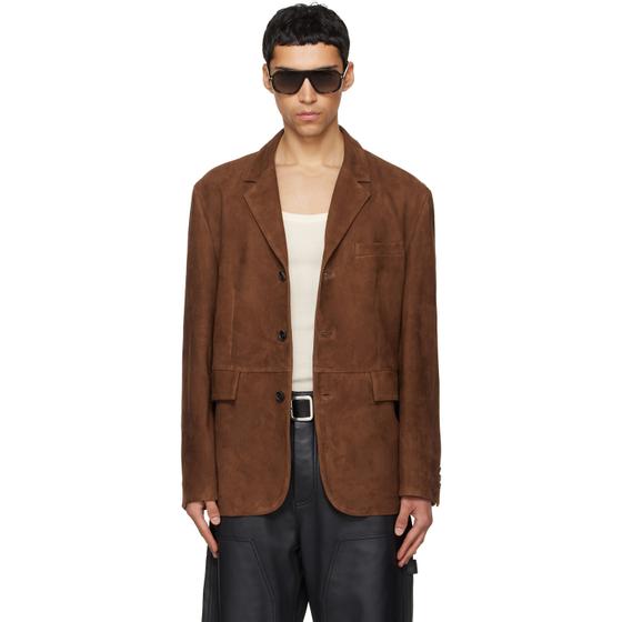 A man wearing a brown suede TONYWACK blazer with sunglasses and black leather trousers