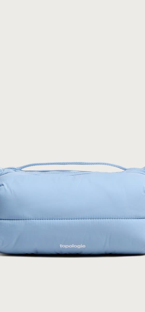 A pale blue Topologie padded shoulder bag with rope drawcords