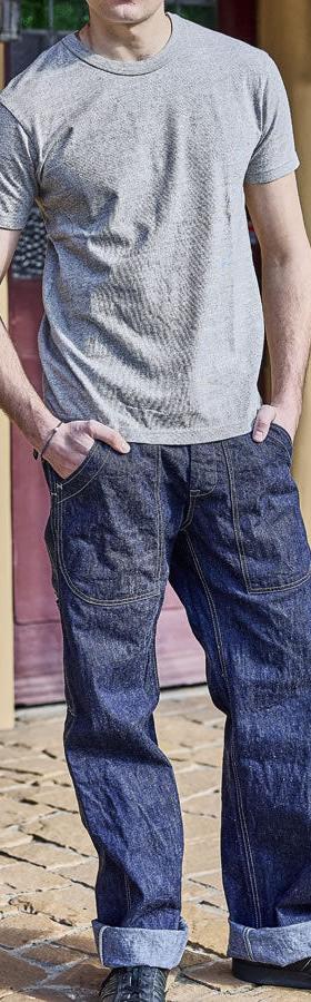 A man wearing UES selvedge denim work trousers with a grey heather tee