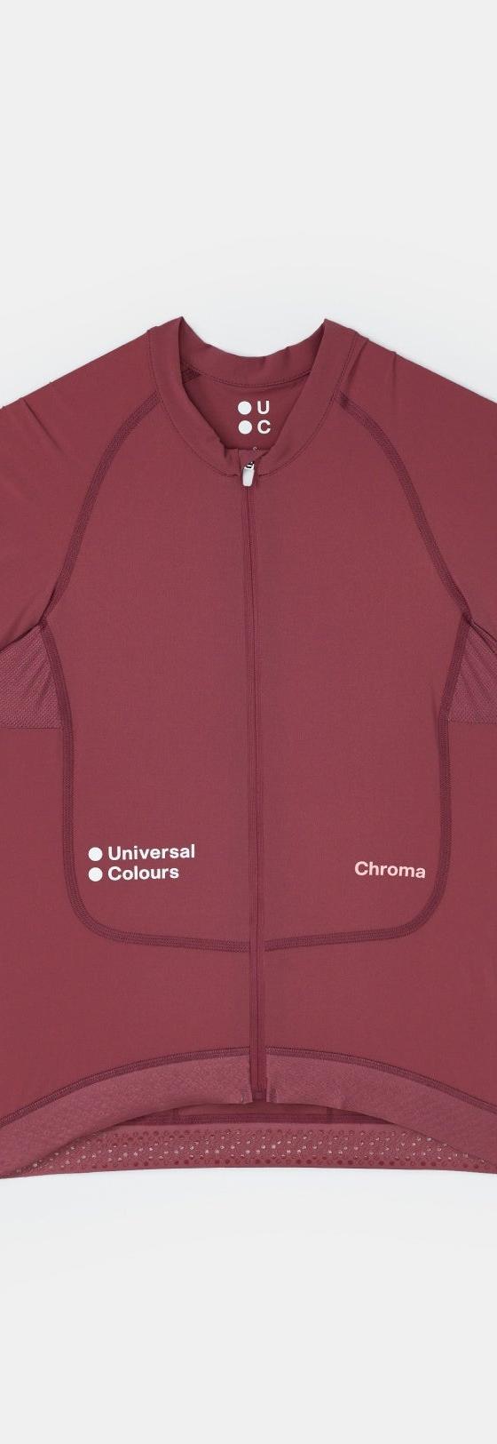 A burgundy Universal Colours Chroma short-sleeve cycling jersey laid flat on a soft grey background