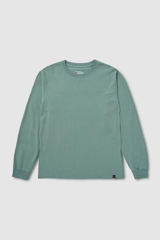 A sage green UNIVERSAL OVERALL long-sleeve cotton tee laid on a plain grey background