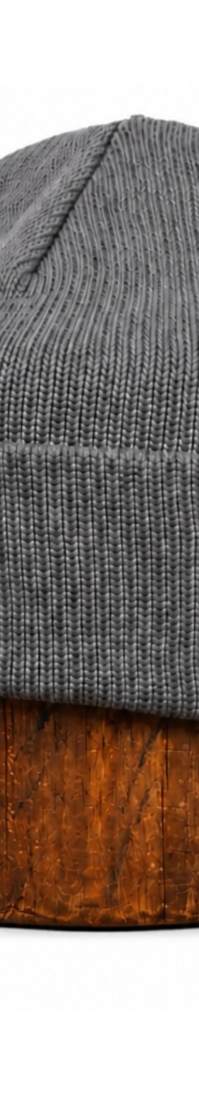A grey ragg wool knit cap displayed on a wooden block