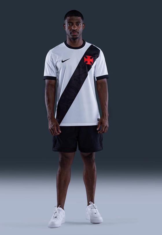 A man wearing a white and black VASCO jersey with black shorts