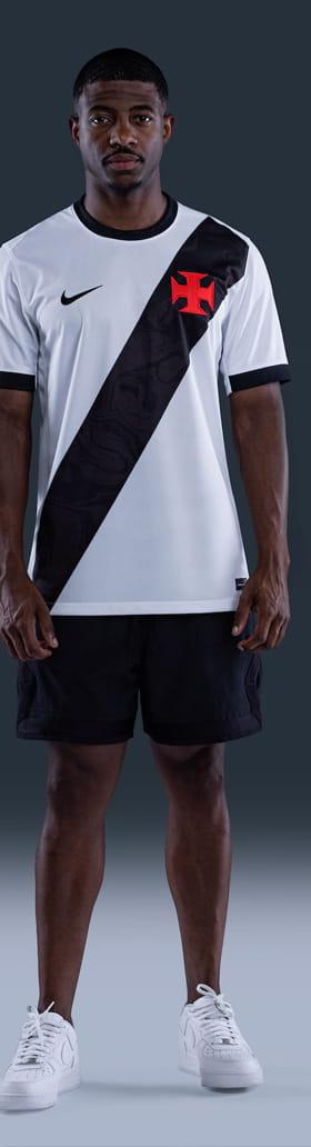 A man wearing a white and black VASCO jersey with black shorts