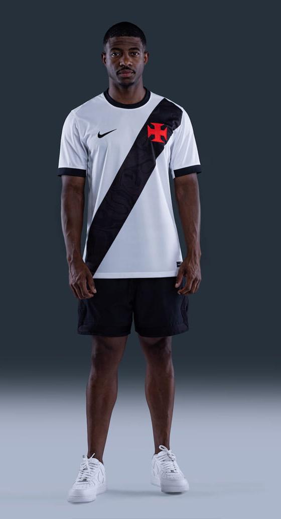 A man wearing a white and black VASCO jersey with black shorts