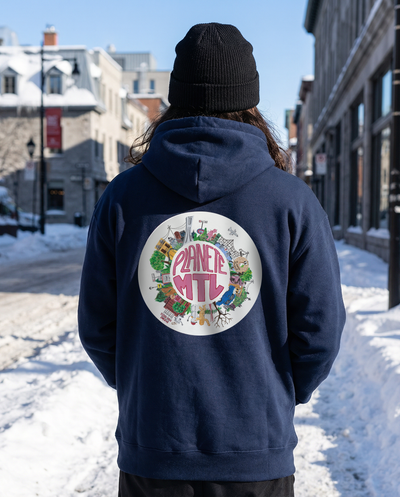 A man wearing a navy Vêtements Le Cartel hoodie with a Planète MTL back print, photographed on a snowy Montreal street