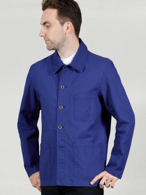 A man wearing a bright blue Vétra cotton chore jacket over a white tee