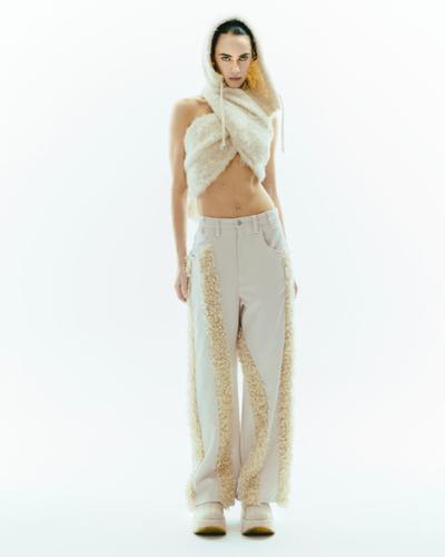 A woman wearing a cream faux-fur hooded scarf and fur-panelled ViaVanda trousers