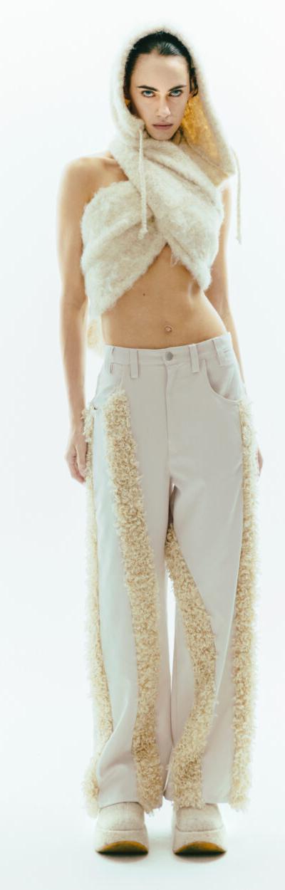 A woman wearing a cream faux-fur hooded scarf and fur-panelled ViaVanda trousers