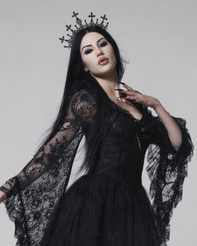 A woman wearing a black lace Widow gown with a cross crown