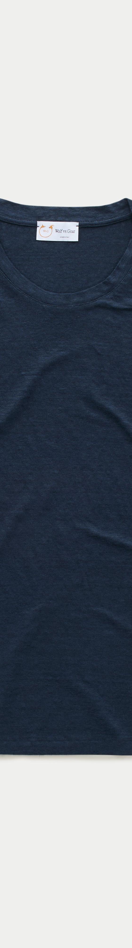 A navy slub-cotton crewneck T-shirt by Wolf vs Goat photographed on a plain off-white background