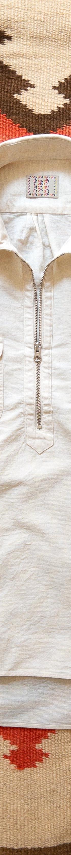 A cream Wythe half-zip popover workshirt laid flat on a woven Southwestern blanket
