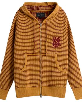 A mustard yellow waffle-knit zip-up hoodie with a burgundy embroidered logo