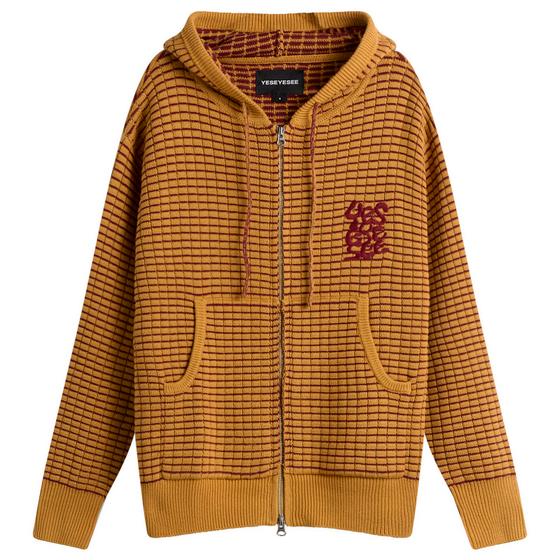 A mustard yellow waffle-knit zip-up hoodie with a burgundy embroidered logo