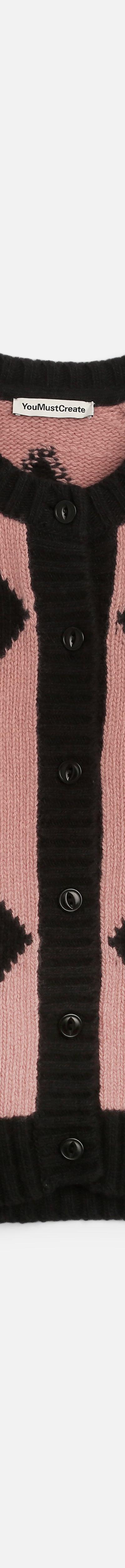 A pink and black diamond-patterned YMC knitted cardigan on a plain white background