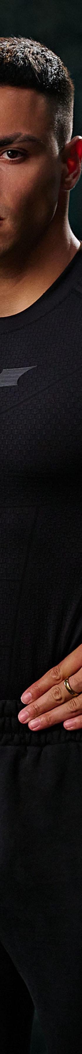 A man wearing a black YoungLA compression top and black sweatpants in a gym