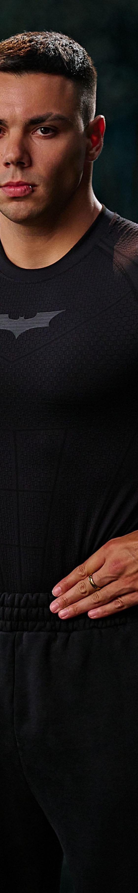 A man wearing a black YoungLA compression top and black sweatpants in a gym