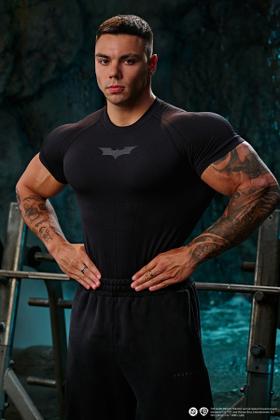 A man wearing a black YoungLA compression top and black sweatpants in a gym