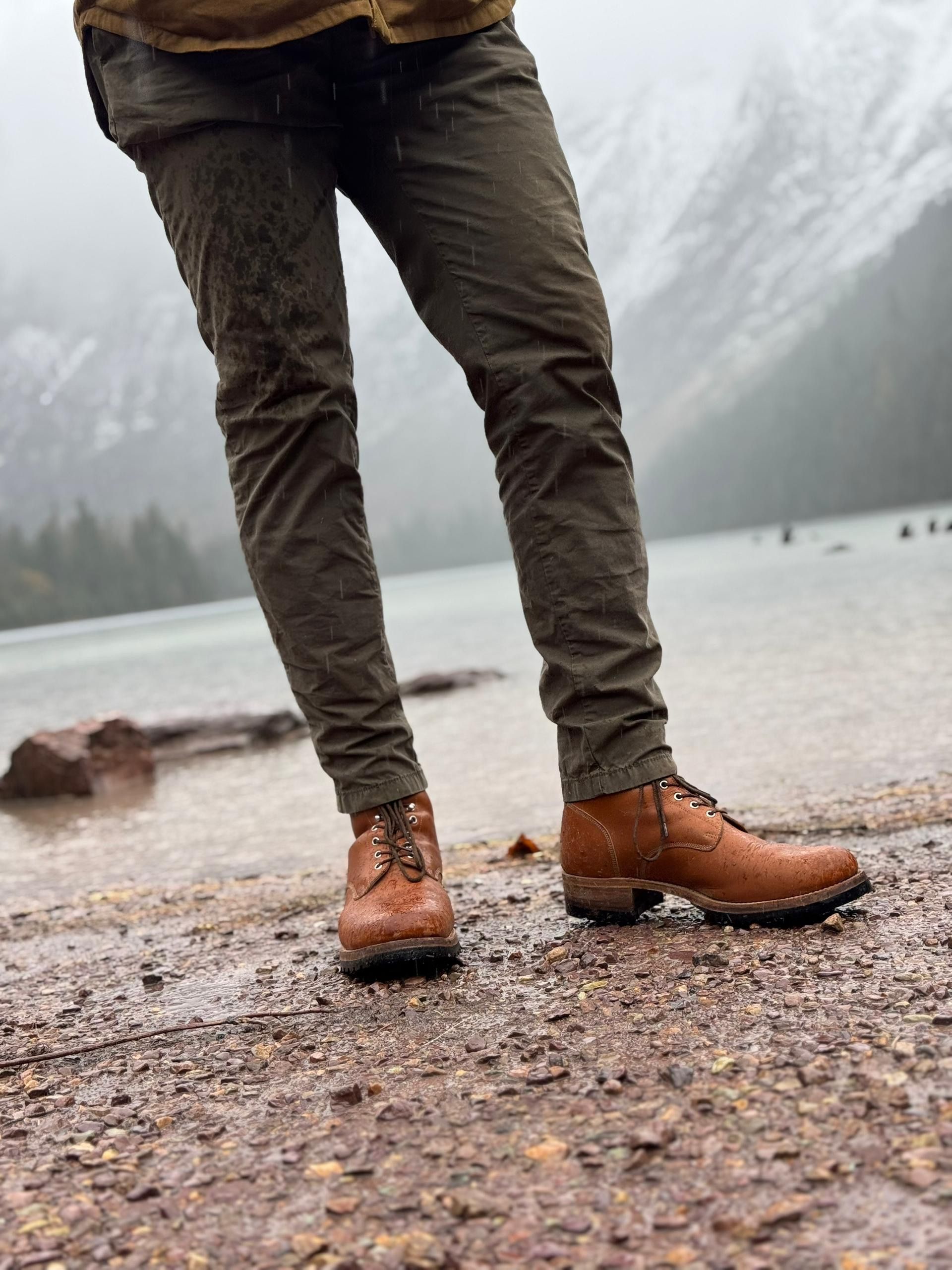 Saddleback Huntsman boots in Natural worn with olive trousers on a lakeshore