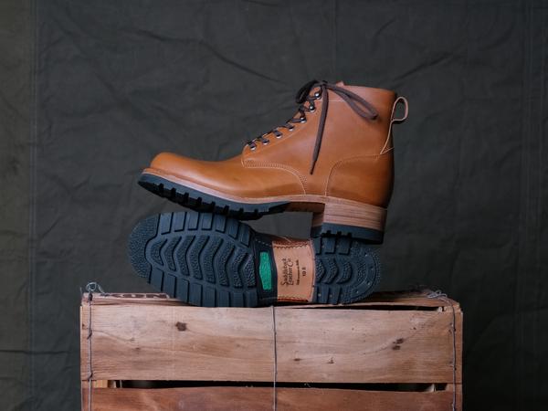 The lugged rubber sole of a Saddleback Huntsman boot, propped against the other boot