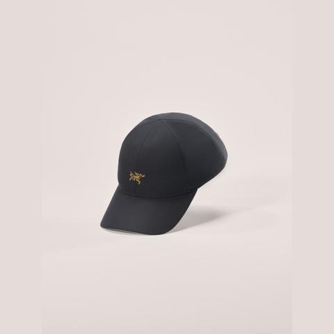A black Arc'teryx cap with a small gold bird logo