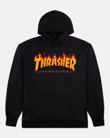 A black Thrasher Flame Logo hoodie laid flat, front view, with the yellow-orange flame Thrasher Magazine logo across the chest, black drawcords at the hood and a kangaroo pocket, on a light grey background.