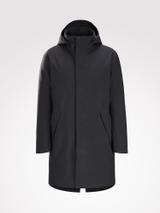 A black knee-length hooded coat shown on an invisible mannequin from the front, closed with a concealed placket, with angled hand pockets and a hem that dips lower at the back, against a plain pale grey background.